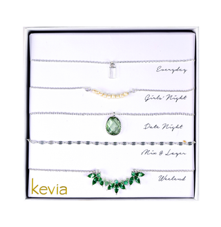 Five-piece silver necklace set featuring pearls, crystals, and a bold pendant in garnet red or chrysolite green, packaged in a gift box.