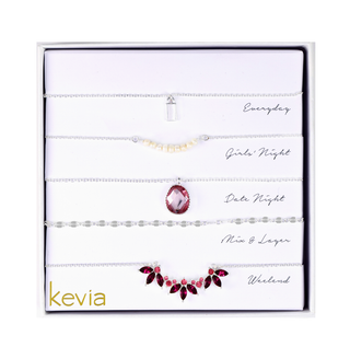Silver necklace set with pink and crystal accents in layered chain styles