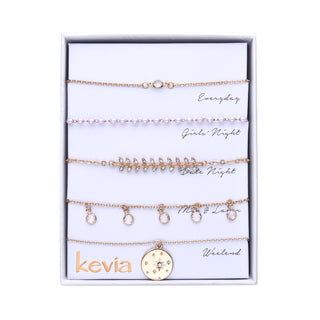 Five-piece bracelet set featuring pearl accents, crystal charms, leaf motif, and a celestial medallion, available in gold or silver, with options for amethyst or chrysolite crystals, packaged in a gift box.