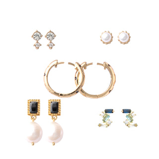 Five-piece gold earring set featuring gem-studded huggies, pearl drop earrings, and classic stud designs with black accents and luminous pearls, packaged in a gift box.