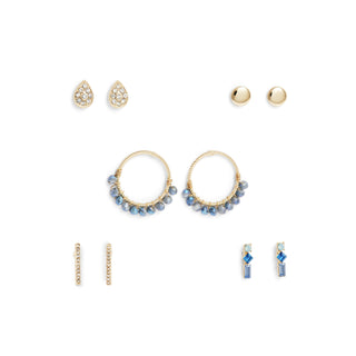 Five-piece gold earring set featuring blue beaded hoops, crystal drop earrings, pavé teardrop studs, gold ball studs, and gold bar earrings, packaged in a gift box.