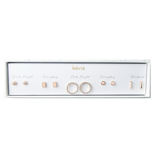 Five-pair rose gold earring set with pavé studs, geometric shapes, crystal hoops, and minimalist bars, packaged in a gift box.