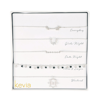 Five-piece silver necklace set with crystal charms, onyx beads, celestial medallion, and geometric accents, packaged in a gift box.