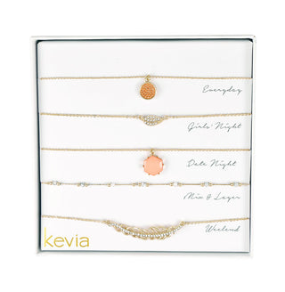 Five-piece gold necklace set featuring coral pendants, pearl accents, and crystal details, packaged in a gift box.