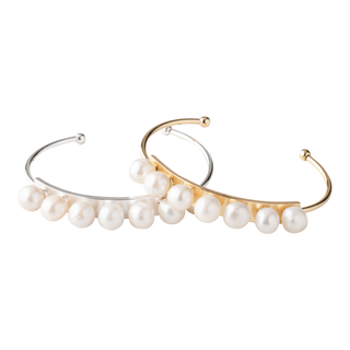 Two freshwater pearl cuff bracelets, one plated in gold and the other in silver, arranged side by side against a white background.