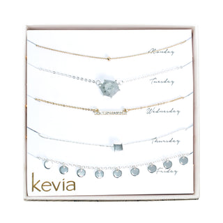 Five-piece mixed metal necklace set with hexagon stone, crystal bar, silver fringe, and gold bead accents
