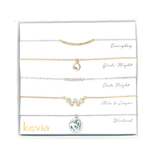 Five-piece necklace set with mixed metal chains, crystal accents, and charm pendants in gold and silver