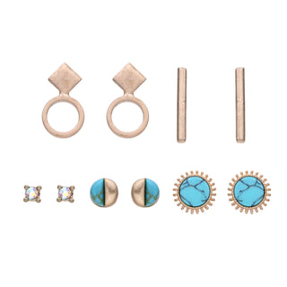 Five-pair earring set featuring turquoise gemstone studs, hammered geometric drops, minimalist bars, crystal-accented studs, and textured gold-tone circles, packaged in a gift box.