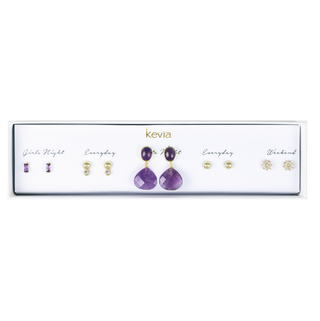 Five-pair gold earring set packaged in a gift box featuring faceted amethyst drops, crystal sunburst studs, gold ball studs, and purple baguette posts.