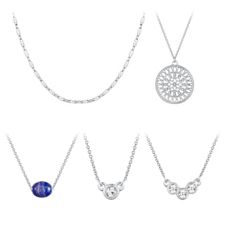Five-piece silver necklace set featuring crystal medallion, figaro chain, bezel-set crystal, blue stone, and trio crystal pendant