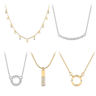Five-piece gold and silver-tone necklace set featuring charm drops, crystal pavé bar, circle pendant, vertical bar with crystals, and gold ring charm.