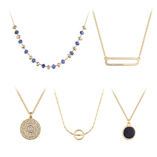 Five-piece gold necklace set featuring blue beaded strand, pavé pendant, crystal circle medallion, open-ring charm, and dark blue stone round pendant