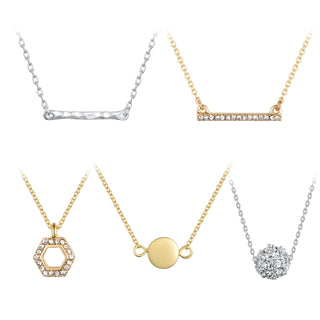 Five-piece necklace set with gold and silver chains featuring designs including a hammered silver bar, gold pavé bar, crystal hexagon, gold disc, and silver pavé ball pendant.