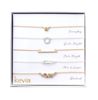 Five-piece gold and silver necklace set featuring pastel gemstone accents, gold bar, crystal circle charm, and smooth glass pendant, packaged in a gift box.