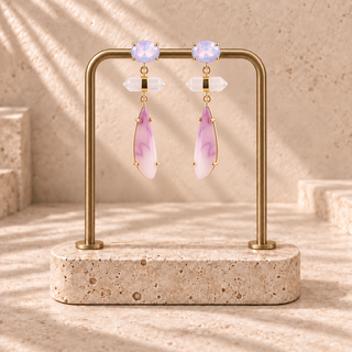 Gold tiered drop earrings with oval iridescent studs, clear crystal bars and pink elongated pendants.