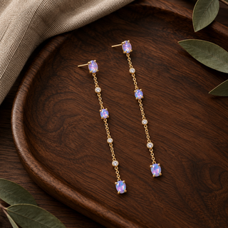 Long gold chain drop earrings with spaced opal and crystal accents.