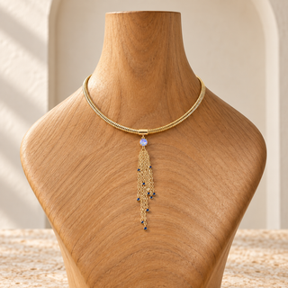 Gold choker necklace with an opal-accented chain tassel pendant.