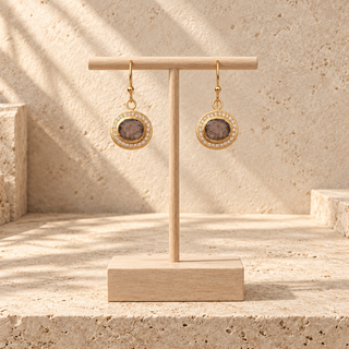Small gold oval drop earrings with brown stones and clear crystal borders.