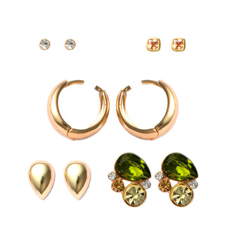 Five piece earring set packaged in a gift box featuring one pair of small round clear crystal stud earrings, one pair of square champagne crystal stud earrings set in gold, one pair of smooth gold teardrop stud earrings, one pair of rounded gold hoop earrings, and one pair of clustered stud earrings with a green teardrop crystal, a round champagne crystal, and small clear crystal accents.