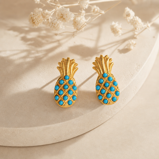 Gold pineapple stud earrings with turquoise bead accents.