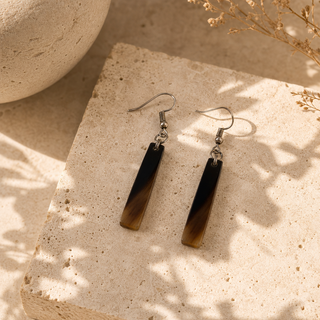 Natural horn bar drop earrings with black-to-brown coloring and dark hook wires.