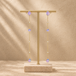 Long gold chain drop earrings with spaced opal and crystal accents.