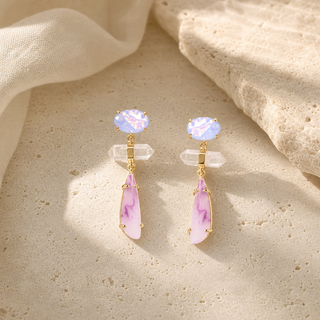 Gold tiered drop earrings with oval iridescent studs, clear crystal bars and pink elongated pendants.