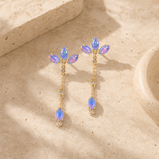 Gold chain drop earrings with marquise opal clusters and single opal pendants.