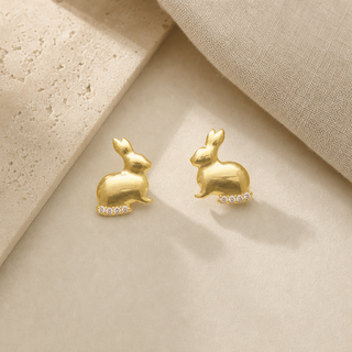 Gold rabbit stud earrings with crystal accents along the bases.
