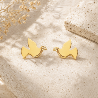 Gold dove stud earrings with small crystal accents.