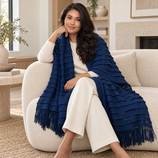 Navy Textured Knit Blanket Scarf — 4. model on a large chair